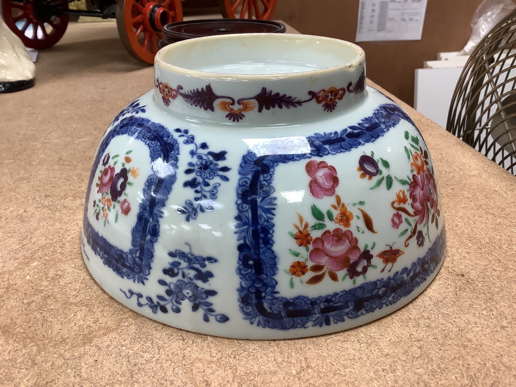 A 18th century Chinese export porcelain footed punch bowl on hardwood stand, diameter 20cm, restored